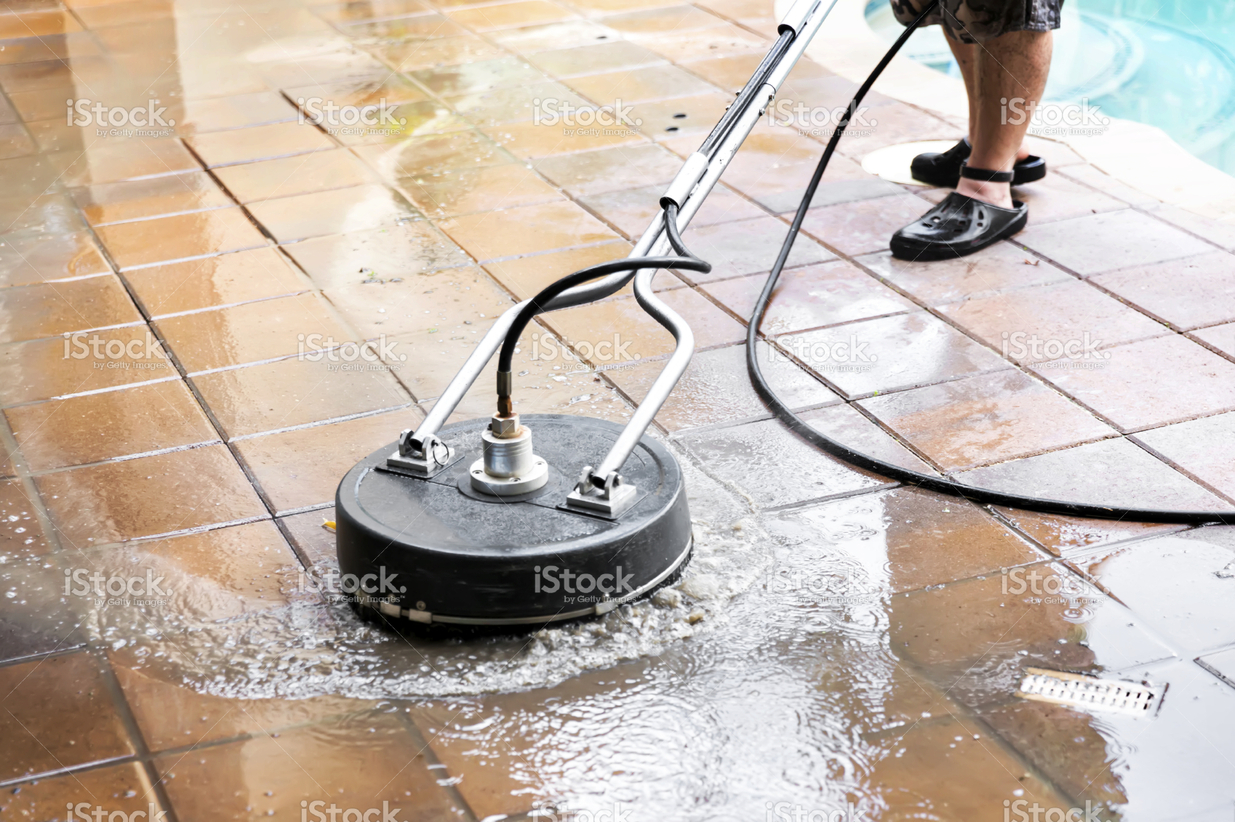 stock-photo-52062386-machine-power-washing-the-patio-tiles-at-a-residential-pool